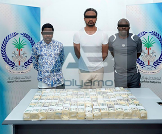 The three suspects pictured with their counterfeit cash