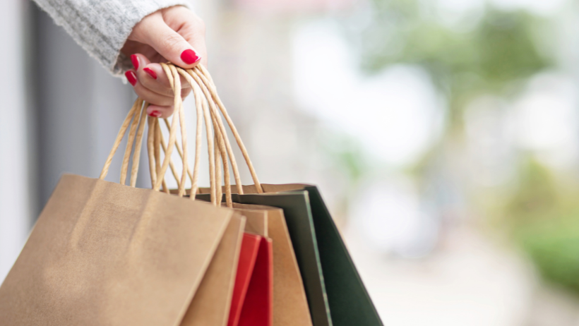 Hand holding holiday shopping bags